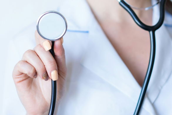 a woman in a white shirt holding a stethoscope